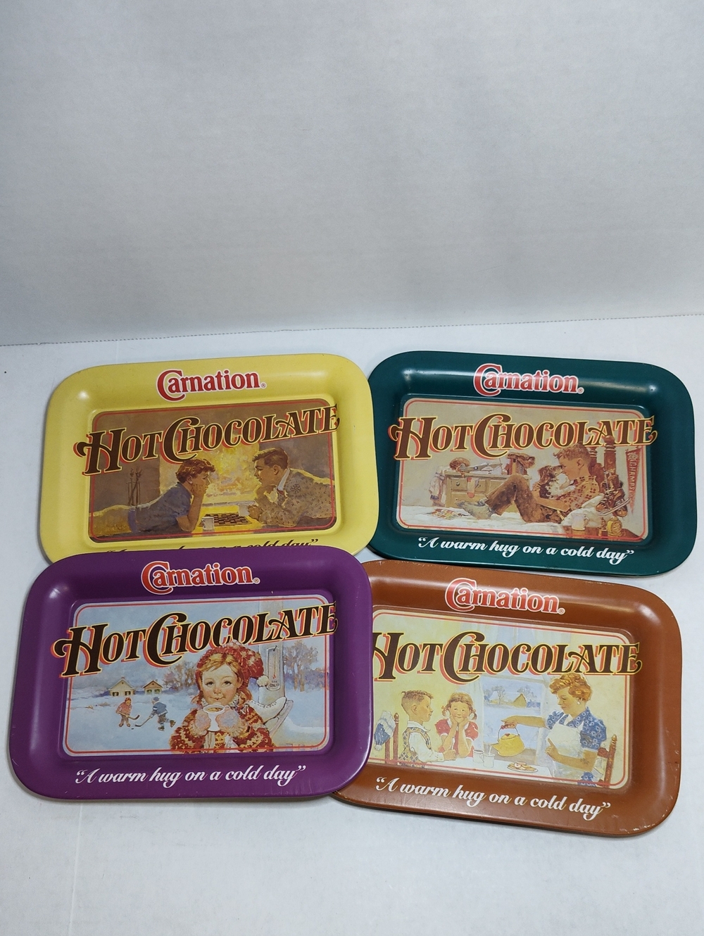 Carnation Hot Chocolate Metal Tray Set of 4 (Yellow, Teal, Purple, Brown)